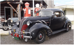 Description: A car parked in front of a house  Description automatically generated